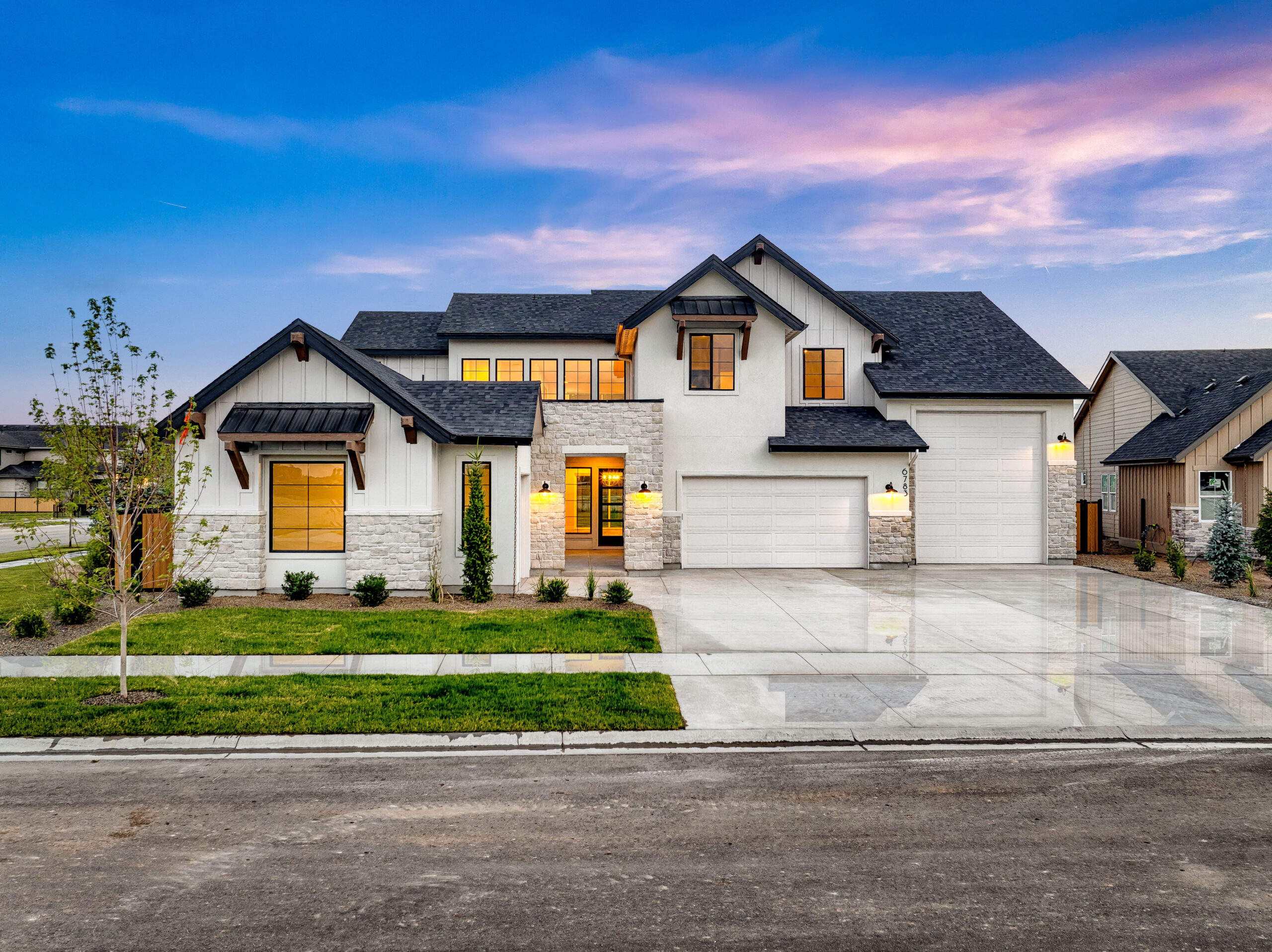 Beautiful white home with lush grass and RV garage